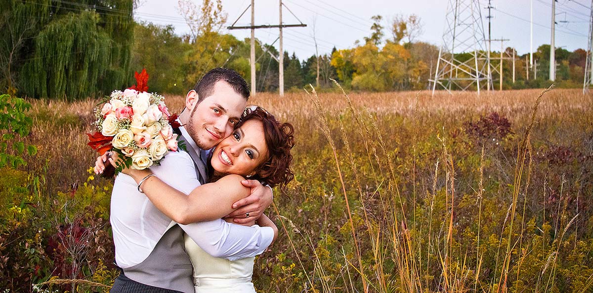Wedding Photographer - Peoria, IL - Dave Zumbek Photography Newly Weds in a Scenic field on their wedding day in Waukegan, IL